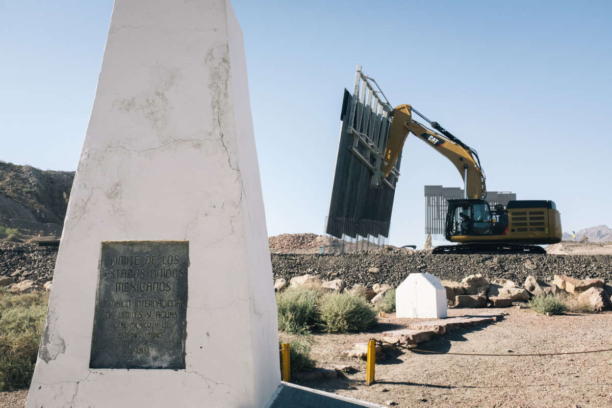 Fisher Industries workers drop pieces of wall into place on May 24, 2019, in Sunland Park, New Mexico, near International Boundary Monument No. 1 where New Mexico, Texas and Mexico come together.