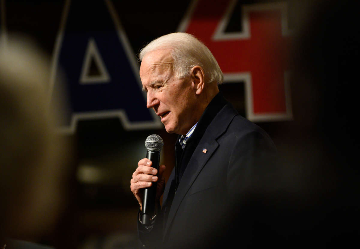 Joe Biden speaks into a microphone