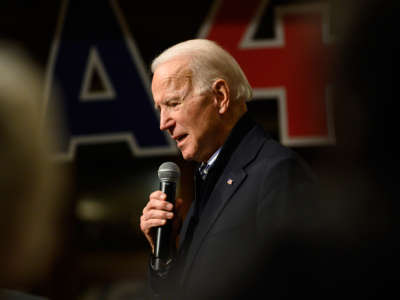 Joe Biden speaks into a microphone