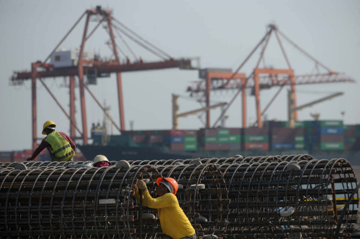 Workers check steel bars at the International Container Terminal Services Incorporated (ICTSI) port in Manila, Philippines, April 18, 2011.