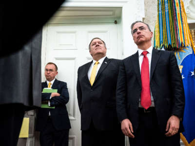 Mick Mulvaney, Mike Pompeo, and White House Counsel Pat Cipollone stand in the Oval Office