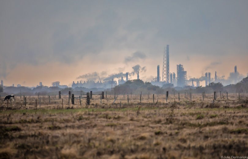 Silhouette of Formosa’s Point Comfort Plant looming over the rural landscape.