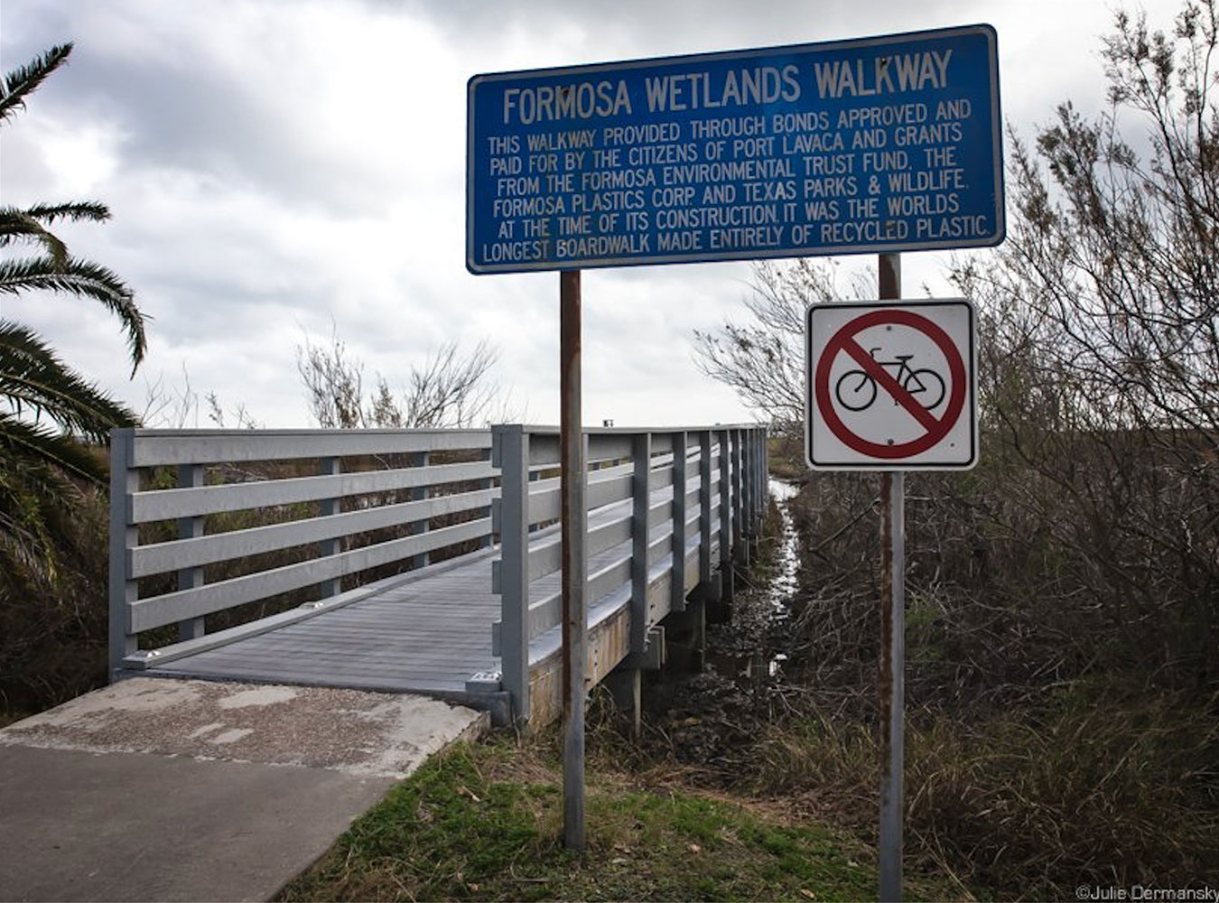 A sign noting the entrance to the Formosa Wetlands Walkway at Port Lavaca Beach. The San Antonio Estuary Waterkeeper describes the messaging as an example of greenwashing.
