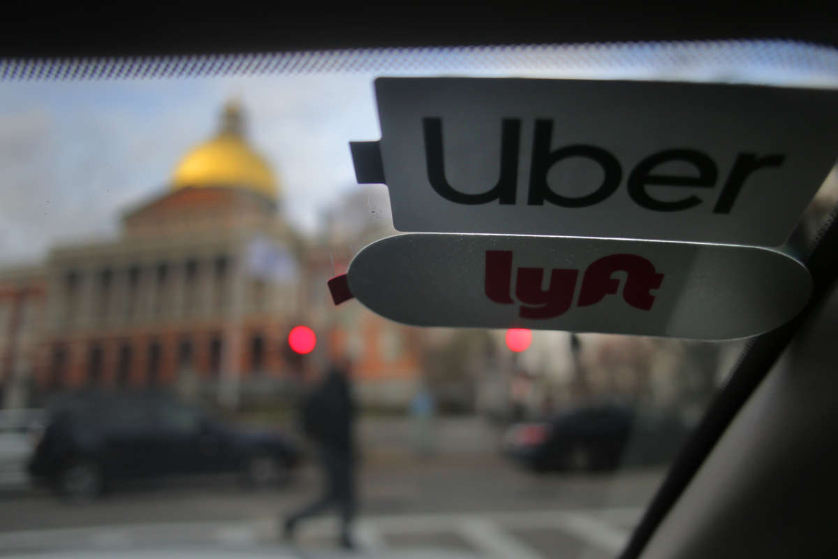 A car with uber and lyft stickers on the windshield