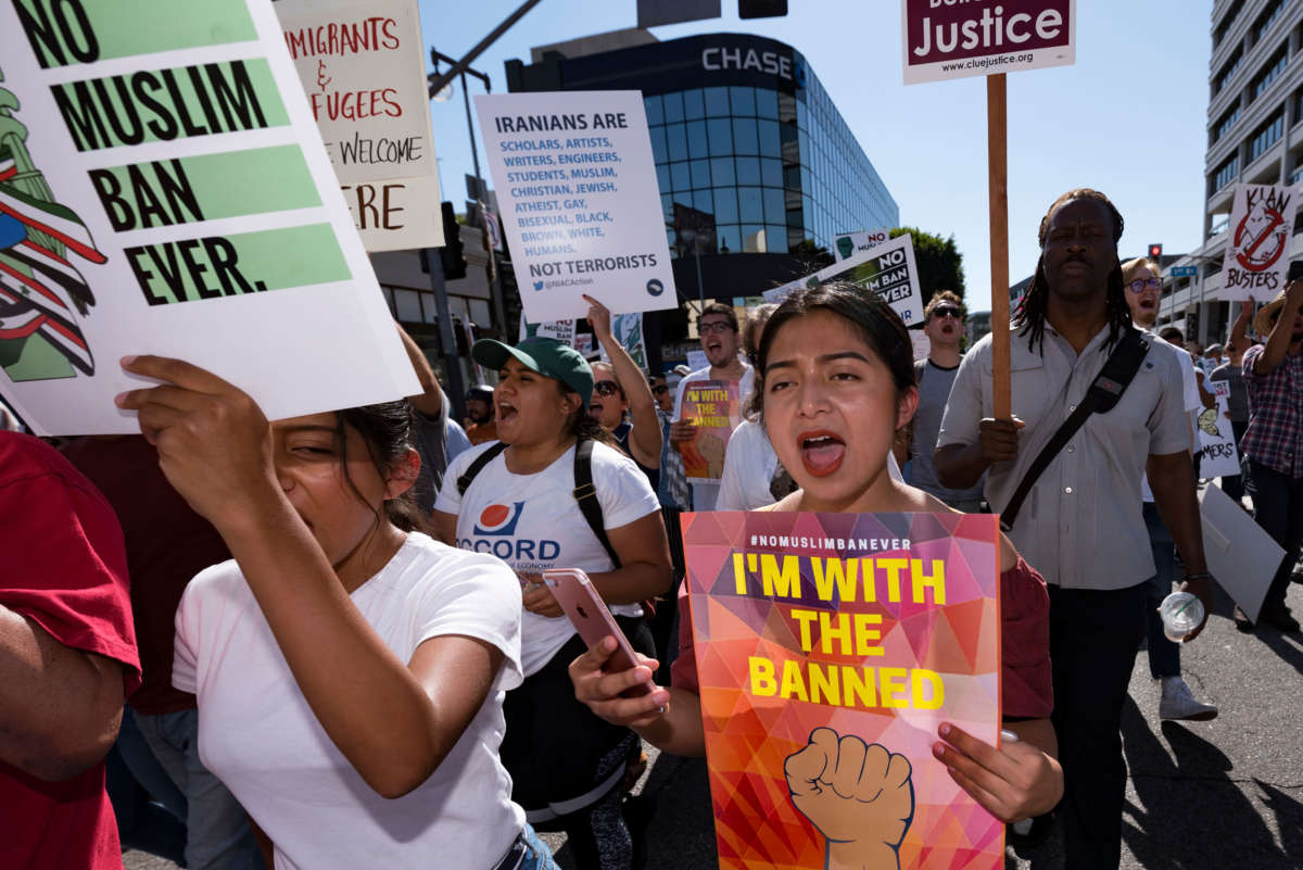 People take part in a protest against President Trump's travel ban in Los Angeles, California, on October 15, 2017.