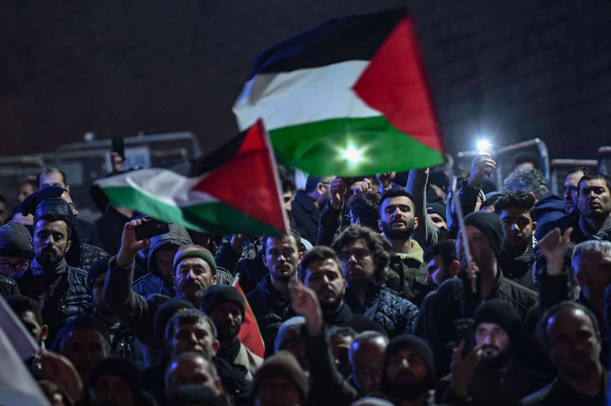 Activists wave Palestinian flags during a protest