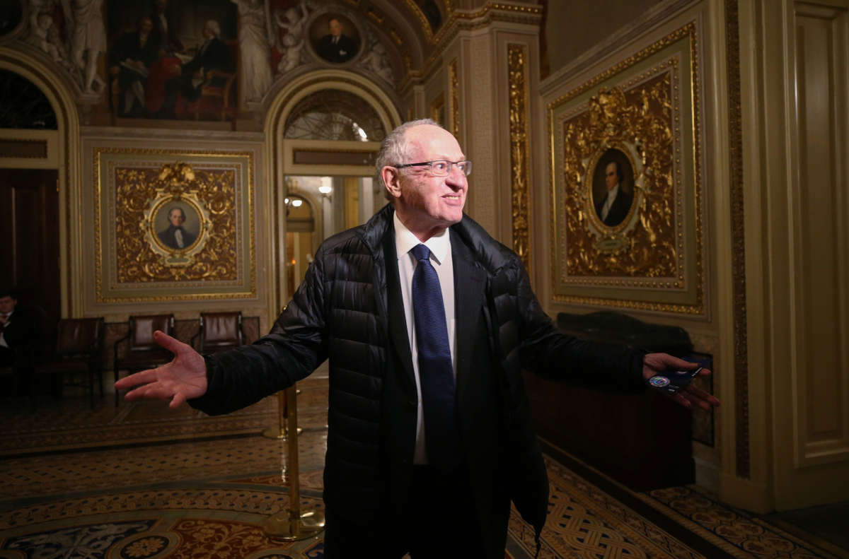 Attorney Alan Dershowitz, a member of President Donald Trump's legal team, gestures to members of the press in the Senate Reception Room during the Senate impeachment trial at the U.S. Capitol on January 27, 2020, in Washington, D.C.