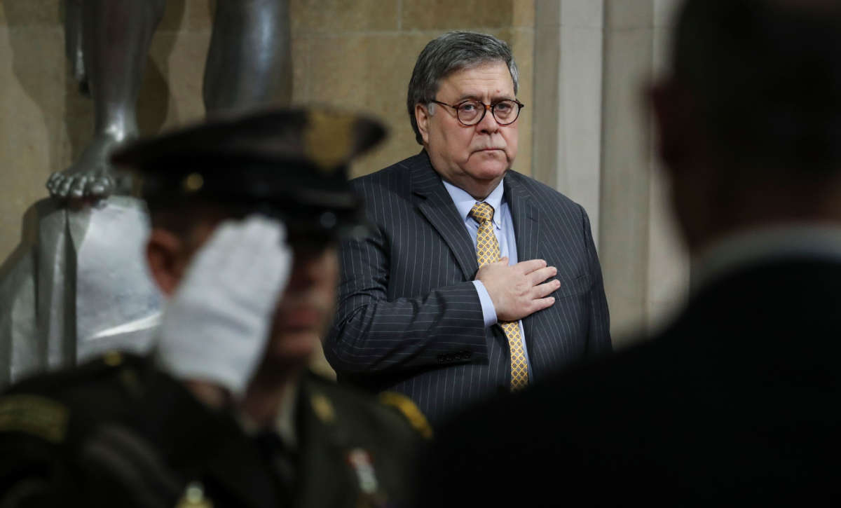 Attorney General William Barr stands for the National Anthem during an event at the U.S. Department of Justice on December 3, 2019, in Washington, D.C.