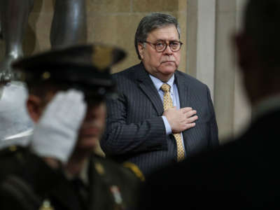 Attorney General William Barr stands for the National Anthem during an event at the U.S. Department of Justice on December 3, 2019, in Washington, D.C.