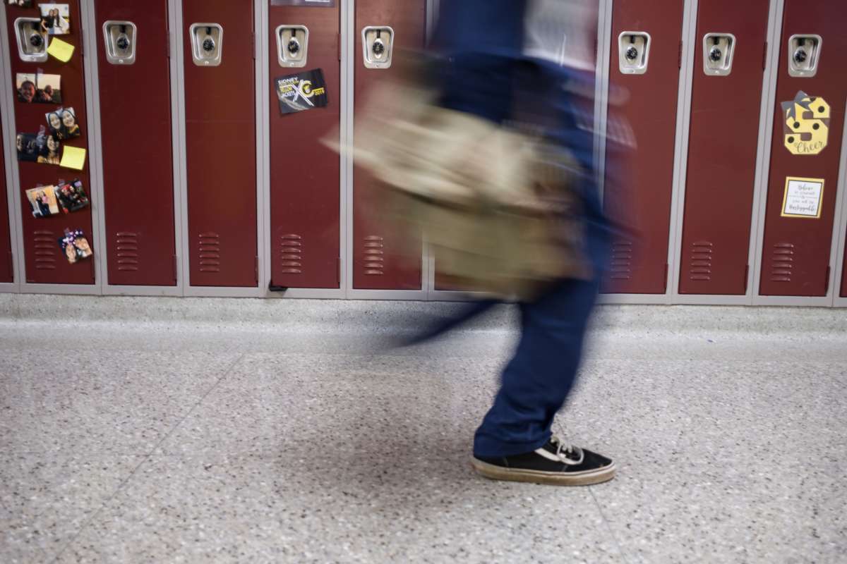 A Sidney High School student walks through the halls in between classes in Sidney, Ohio, October 31, 2019.