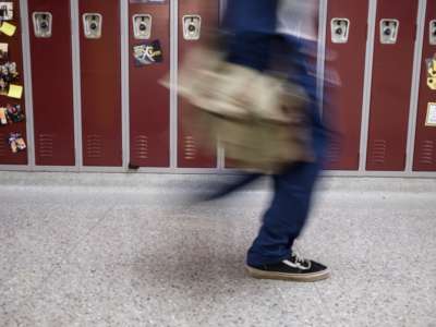 A Sidney High School student walks through the halls in between classes in Sidney, Ohio, October 31, 2019.