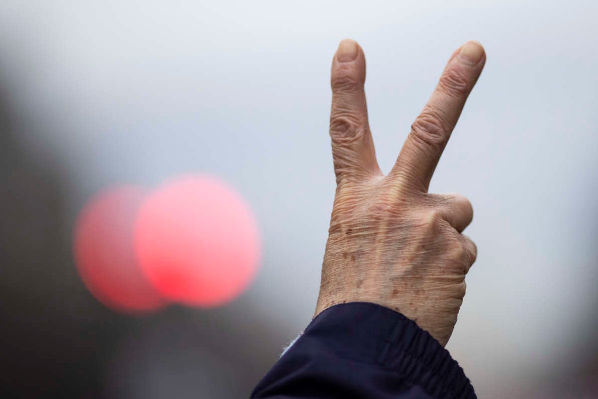 An anti-war demonstrator holds up the peace sign during a demonstration against war in Iraq and Iran on January 4, 2020, in Washington, D.C.