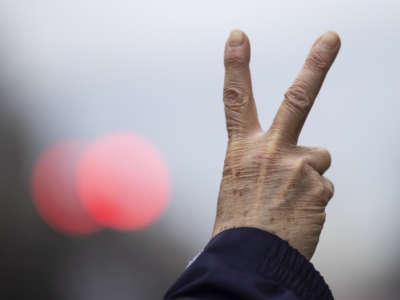 An anti-war demonstrator holds up the peace sign during a demonstration against war in Iraq and Iran on January 4, 2020, in Washington, D.C.