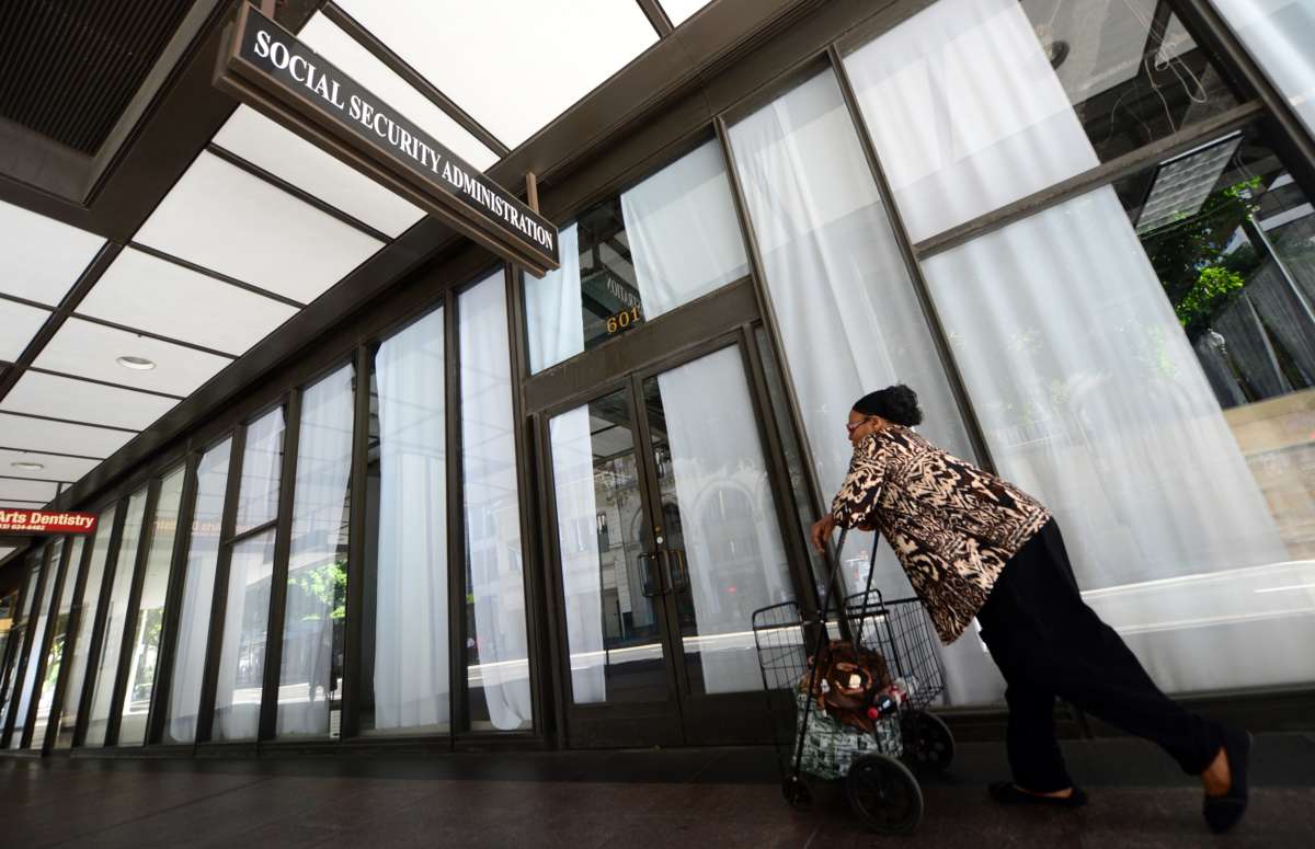 A woman walks past the Social Security Administration office in downtown Los Angeles, on October 1, 2013 in California.