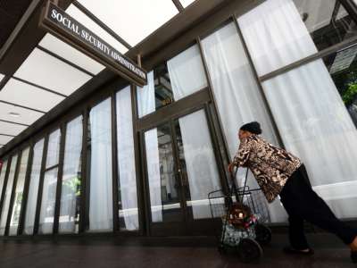 A woman walks past the Social Security Administration office in downtown Los Angeles, on October 1, 2013 in California.