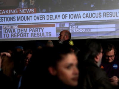 Supporters of Democratic presidential candidate Sen. Bernie Sanders wait for results to come in at his caucus night watch party on February 3, 2020, in Des Moines, Iowa.