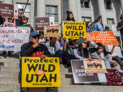 Native American protesters sit on the steps of Utah's Capitol building during a protest to protect the Bears Ears and Grand Staircase Escalante monuments