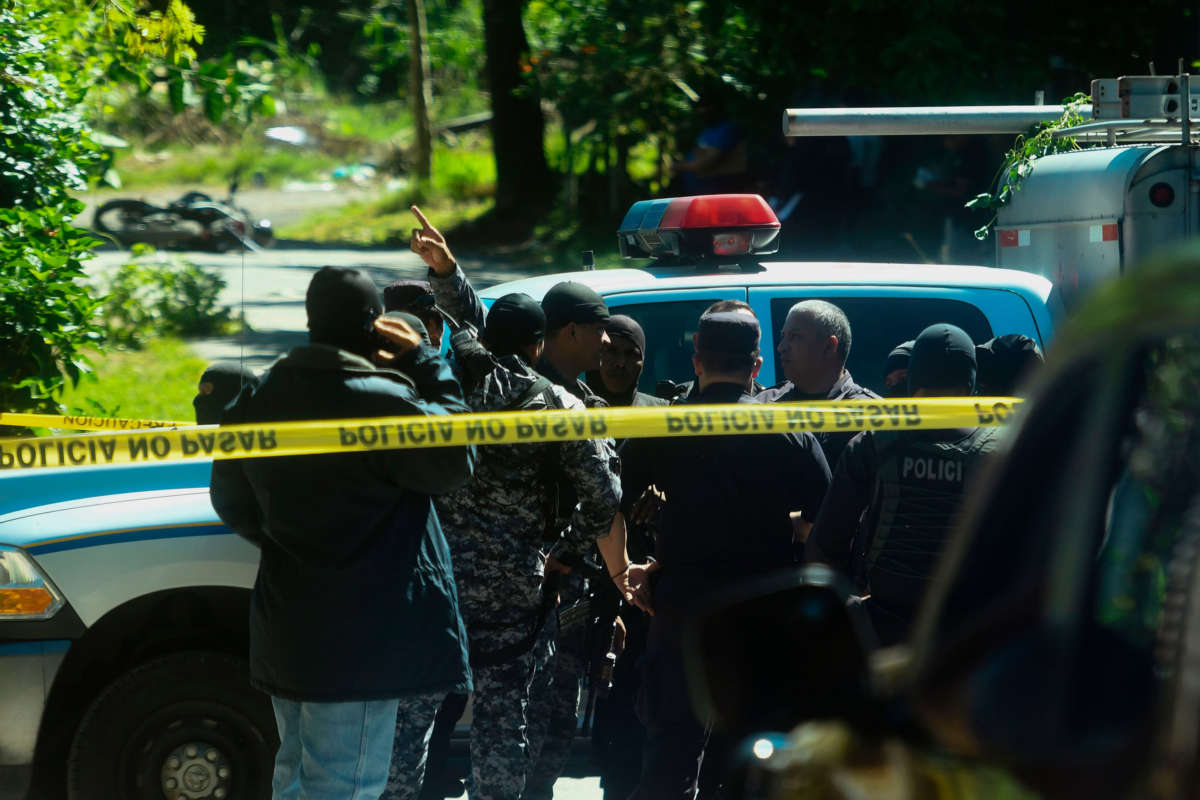 Police investigators work at a crime scene where a member of the National Civil Police was allegedly killed by gang members, in Santa Tecla, El Salvador, on October 17, 2017.