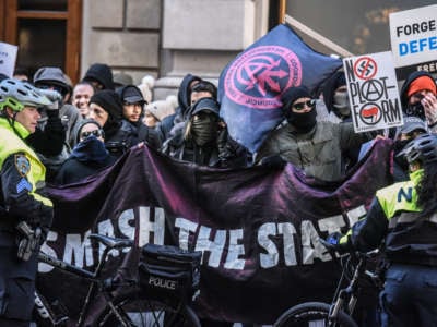 Anti-fascists display signs during a protest