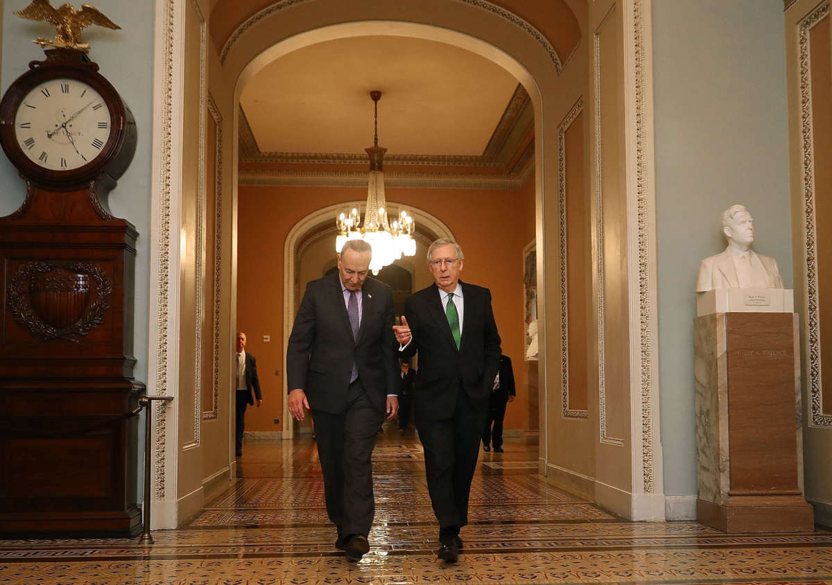 Senate Minority Leader Chuck Schumer and Senate Majority Leader Mitch McConnell walk side-by-side to the Senate Chamber at the U.S. Capitol, February 7, 2018, in Washington, D.C.