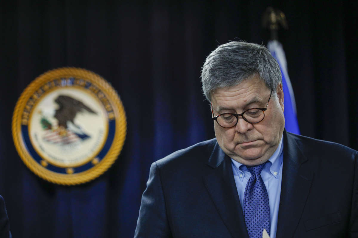 William Barr looks downward