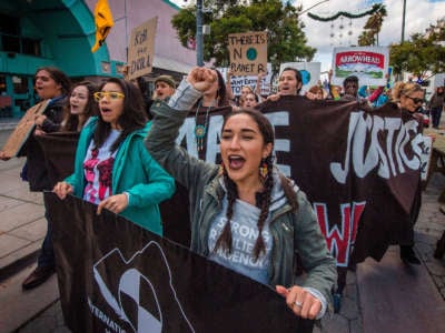 Students and their supporters protest as they demand transformative climate action during the Black Friday sales in Santa Monica, California, on November 29, 2019.