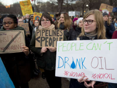 Opponents of the Keystone XL and Dakota Access pipelines hold a rally at Lafayette Park next to the White House in Washington, D.C., on January 24, 2017.