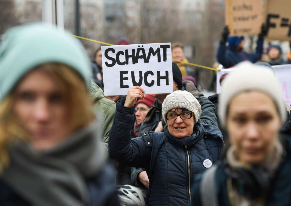 One day after the election of Thuringia's State Premier, a protester holds a placard reading "Shame on you" during a demonstration in front of the State Chancellery in Erfurt, eastern Germany, on February 6, 2020.