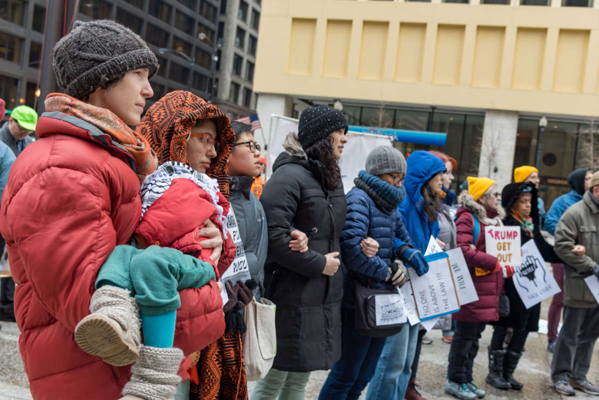 Protesters at The People's Removal Trial of Donald Trump lock arms in Daley Plaza in Chicago on February 1, 2020.