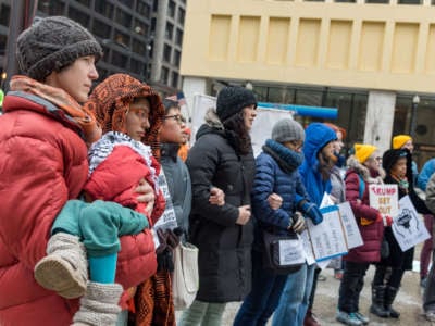 Protesters at The People's Removal Trial of Donald Trump lock arms in Daley Plaza in Chicago on February 1, 2020.