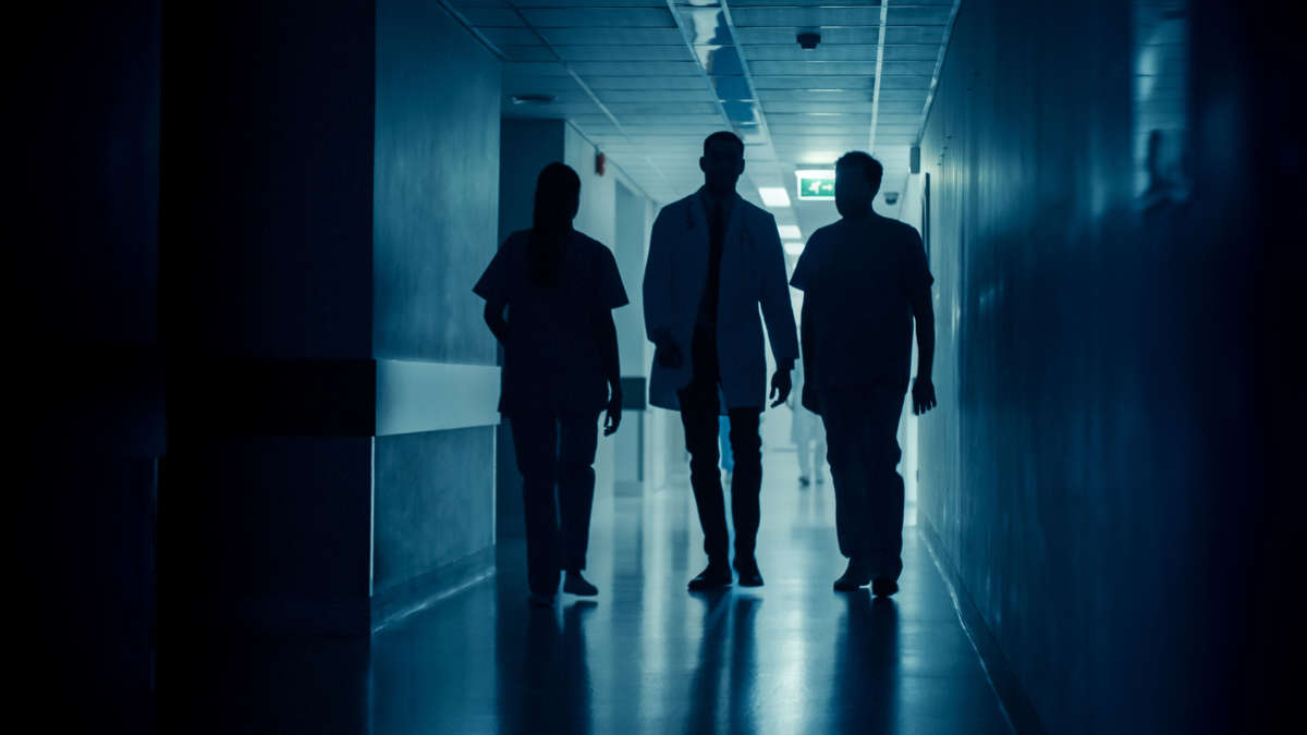 Doctor and nurses in hospital hallway