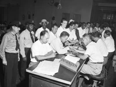 A crowd of veterans wait their turn to get counsel on schooling on the last day to file papers under the G.I. bill in New York, July 25, 1951.