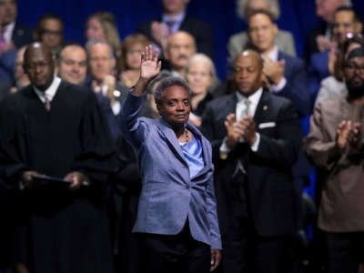 Lori Lightfoot waves at her swearing in ceremony