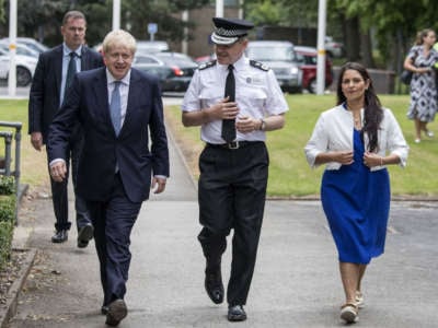 Britain's Prime Minister Boris Johnson, Chief Constable Dave Thompso and Home Secretary Priti Patel arrive to meet graduates of West Midlands Police training centre in Birmingham, central England on July 26, 2019.