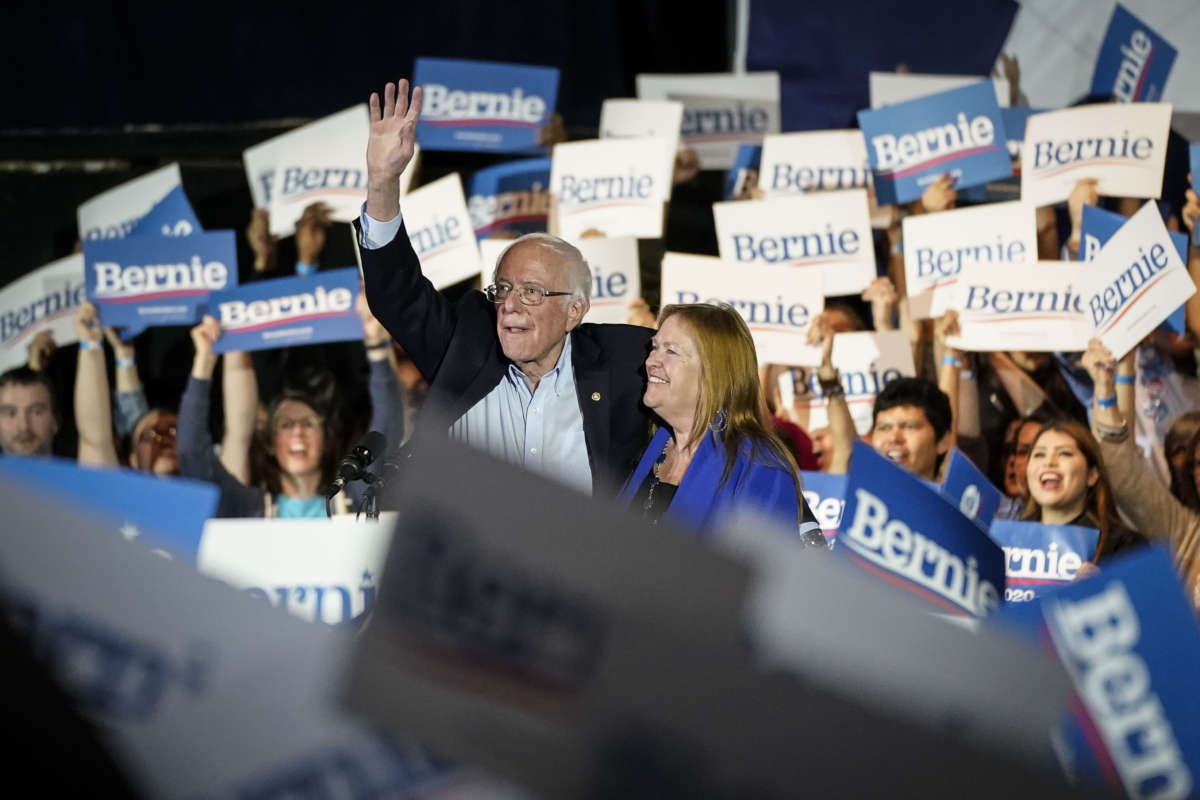 Bernie Sanders stands with his wife at a rally