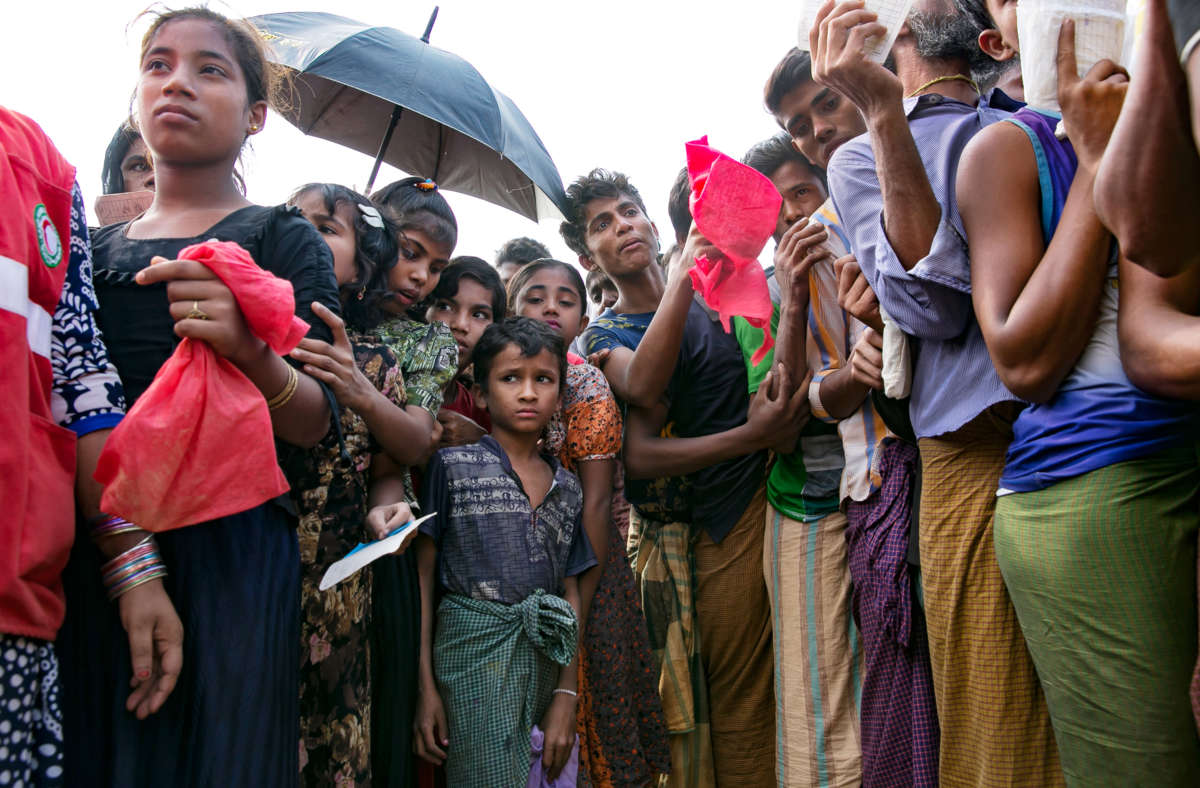 Rohingya refugees stand in a small throng