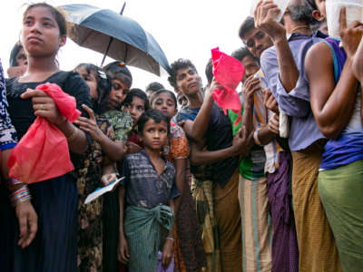 Rohingya refugees stand in a small throng