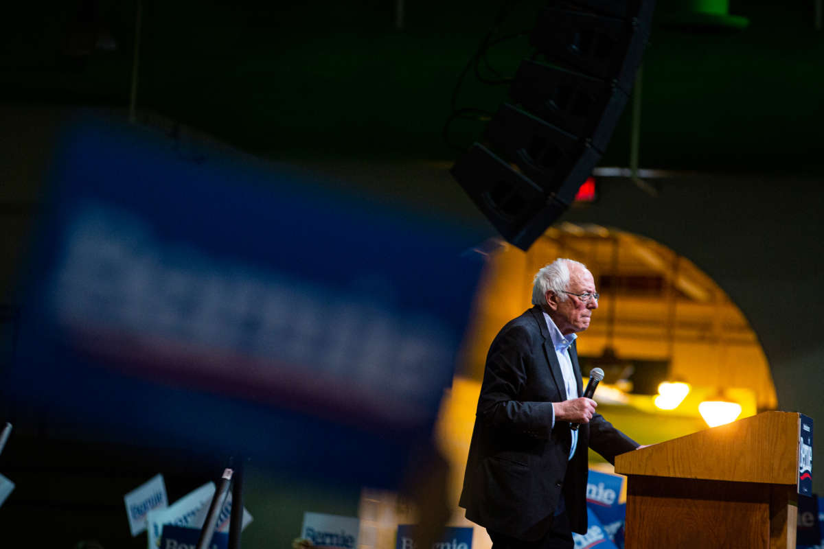 Bernie Sanders stands at a podium during a rally