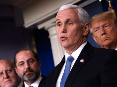 Mike Pence speaks into a microphone at a podium