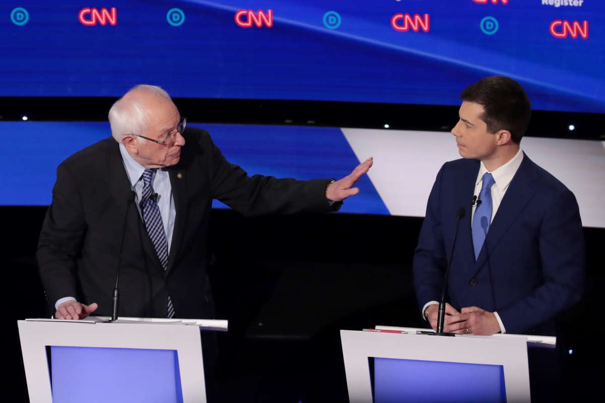 Former South Bend, Indiana Mayor Pete Buttigieg listens to Sen. Bernie Sanders during the Democratic presidential primary debate at Drake University on January 14, 2020, in Des Moines, Iowa.