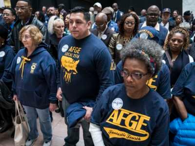 Members and supporters of the American Federation of Government Employees (AFGE) participate in a "Stand Up, Stand In protest in the Hart Senate Office Building Atrium as part of the 2020 Legislative and Grassroots Mobilization Conference on February 11, 2020, in Washington, D.C.