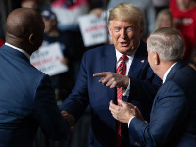 Donald Trump, Sen. Tim Scott and Sen. Lindsey Graham attend a Keep America Great campaign rally at the North Charleston Coliseum in North Charleston, South Carolina, February 28, 2020.