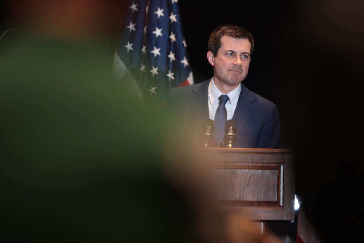 Peter Buttigieg makes a face while standing at a podium