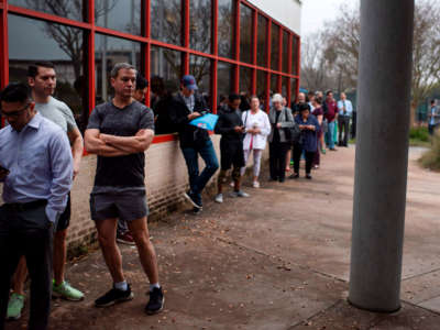 Voters wait in line to cast their ballots during the presidential primary in Houston, Texas, on Super Tuesday, March 3, 2020.