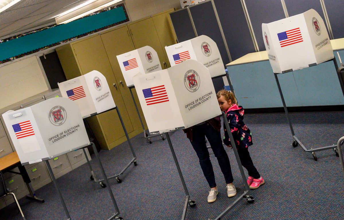 A young girl waits for her mother to vote in the Virginia Democratic primary in Round Hill, Virginia, on March 3, 2020.