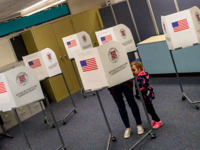 A young girl waits for her mother to vote in the Virginia Democratic primary in Round Hill, Virginia, on March 3, 2020.