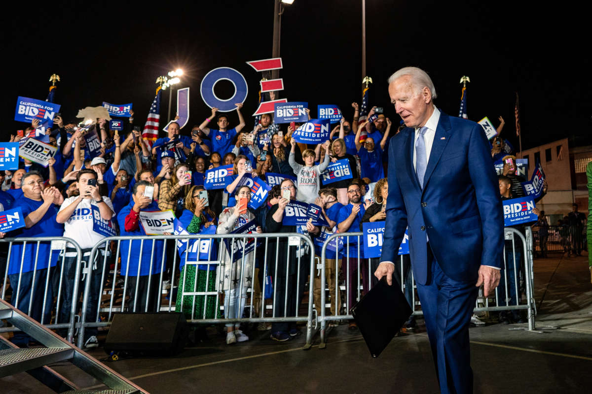 Joe Biden walks by a crowd of supporters