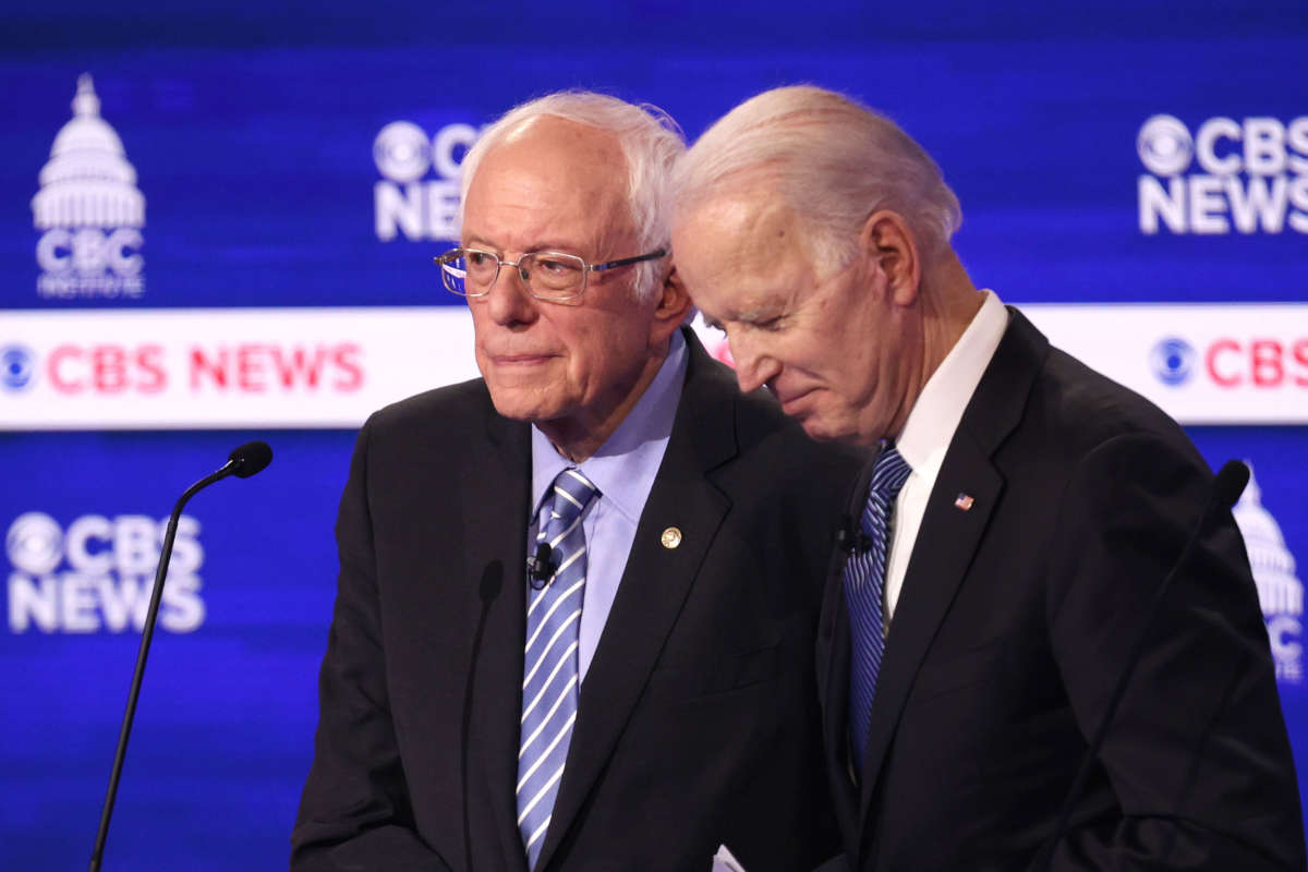 Sen. Bernie Sanders and former Vice President Joe Biden speak during a break at the Democratic presidential primary debate at the Charleston Gaillard Center on February 25, 2020, in Charleston, South Carolina.