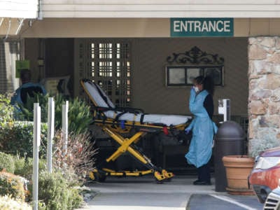 A stretcher is moved from an AMR ambulance to the Life Care Center of Kirkland, Washington on February 29, 2020. The emergence of coronavirus disease at the skilled nursing facility has left two people hospitalized and dozens more with suspicious symptoms.
