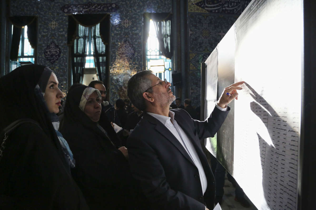 Iranian voters check the voters list during the 11th Parliamentary elections at Hosseiniyeh Ershad polling station in Tehran, Iran, on February 21, 2020.